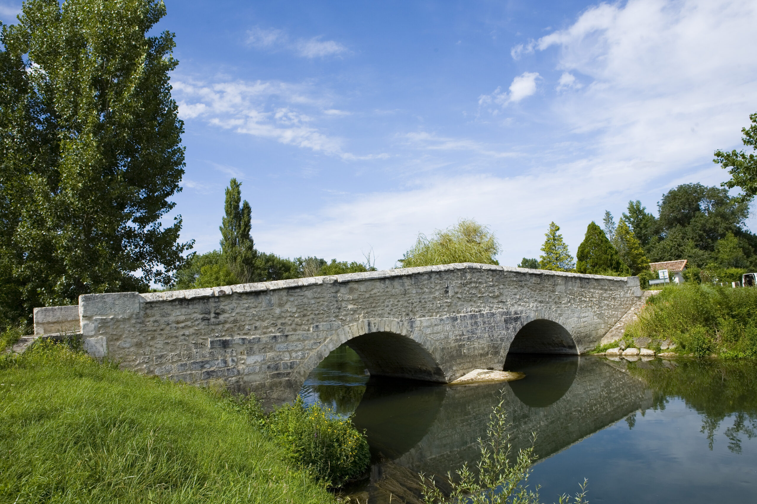 Old stone bridge over river Charente in France