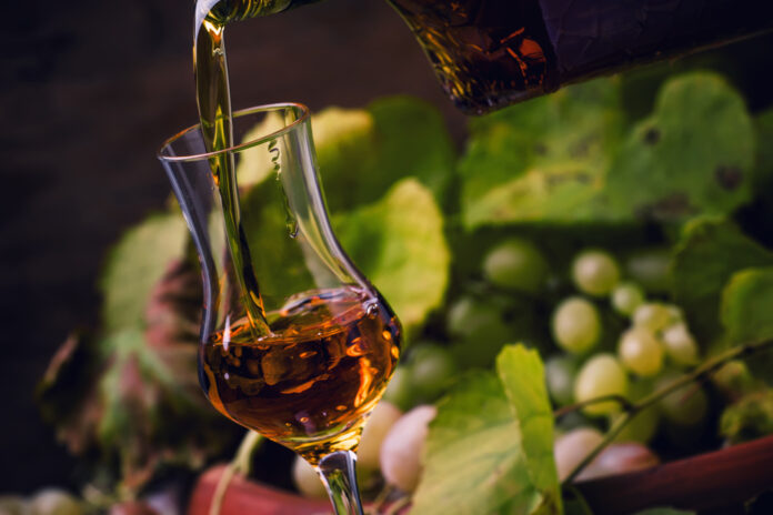 Cognac Being Poured Into Tulip Glass