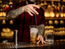 Bartender Stirring a Rusty Nail Cocktail